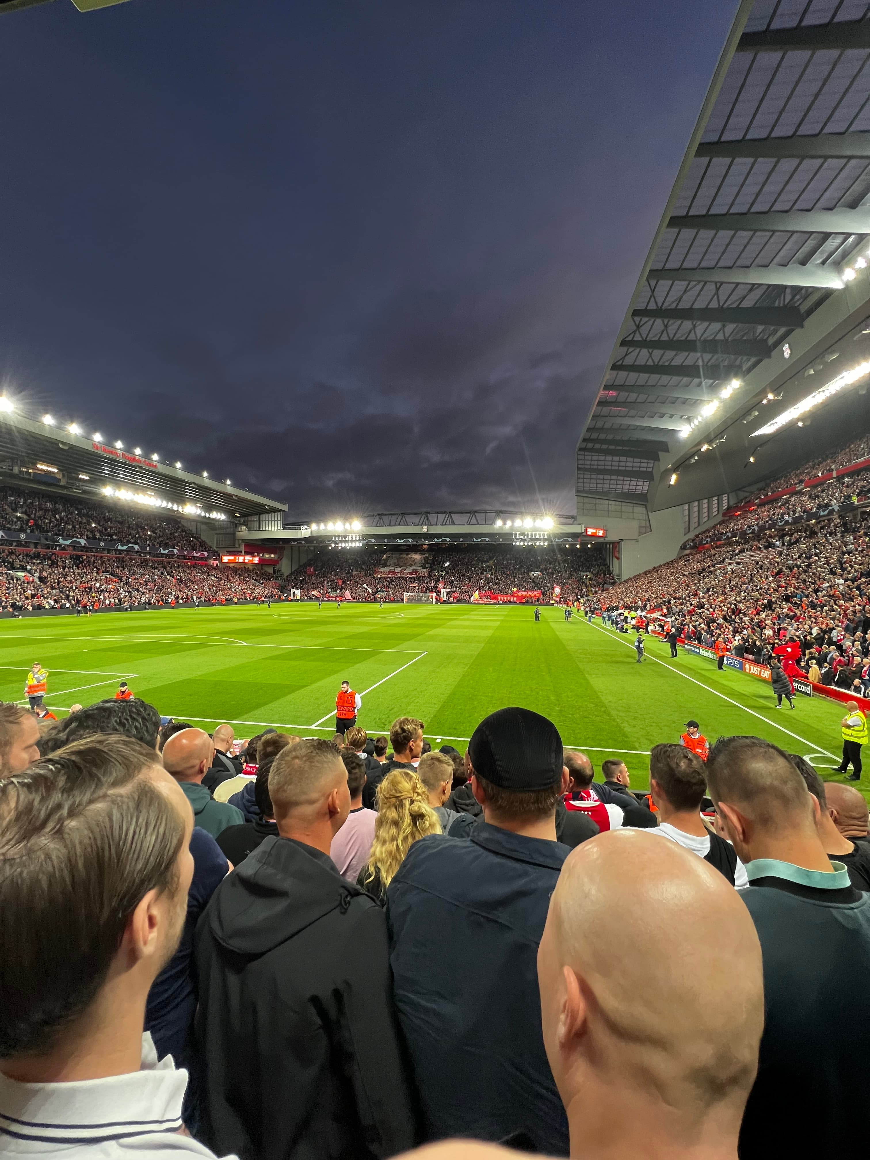 Matchday atmosphere inside Anfield Stadium with fans in the stands