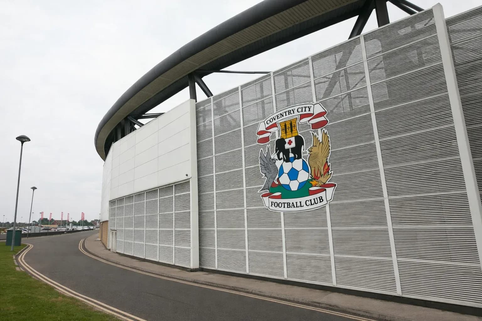 Coventry City stadium exterior with club crest at Coventry Building Society Arena entrance