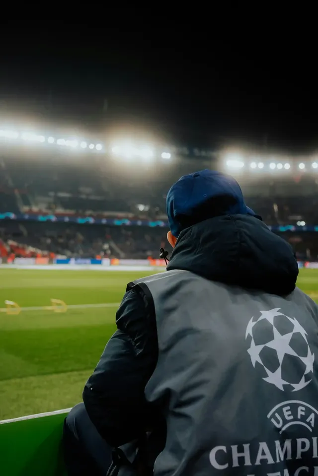 steward with champions league clothes watching a game