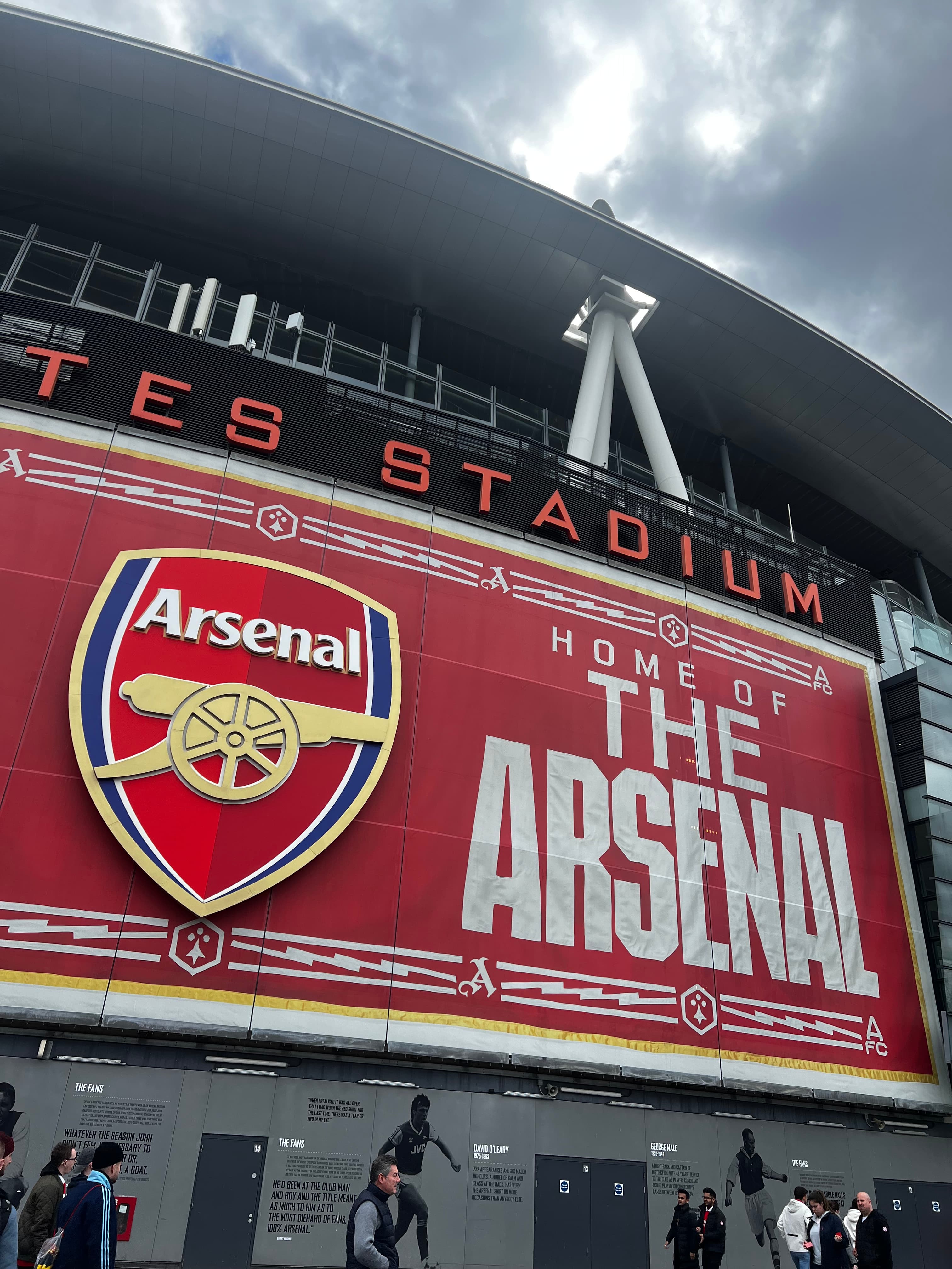 Emirates Stadium Arsenal FC exterior showing club crest and Home of The Arsenal banner North London Premier League venue