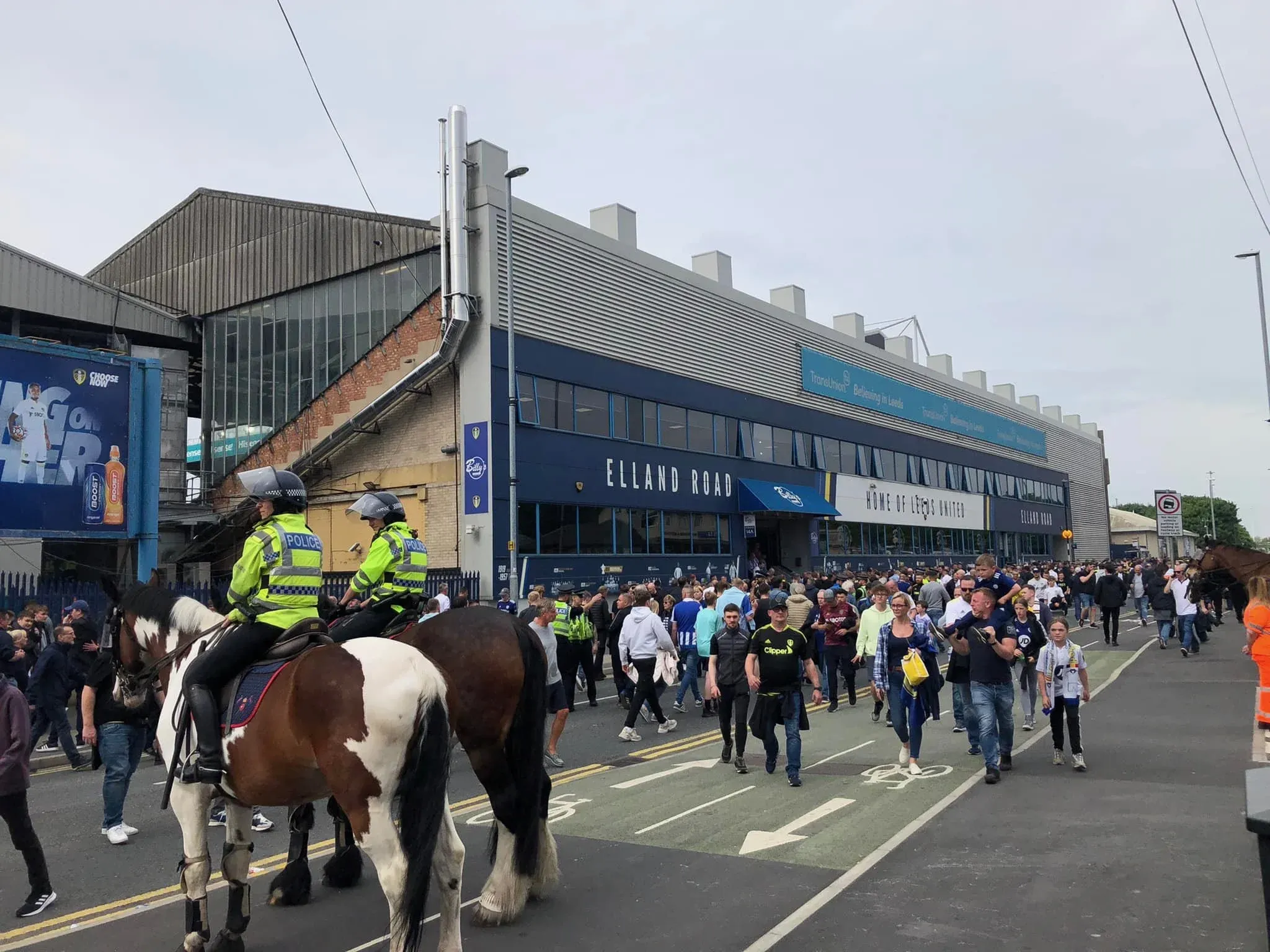 Mounted police officers on horseback managing crowds of Leeds United fans outside Elland Road stadium before a match
